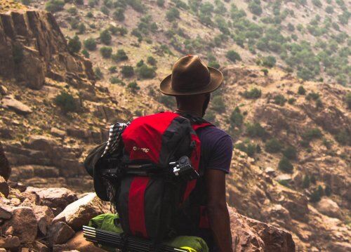Man overlooks hillside view on a hike